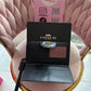 BILLETERA COACH NEGRA CON RELIEVE