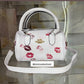 BOLSO COACH DE BESOS IMPORTADA